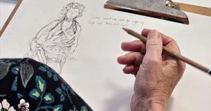 A woman takes part in a life drawing workshop