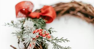 A photograph showing a closeup of a Christmas wreath