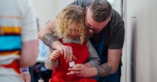 A girl and her dad take part in a creative workshop at The Box
