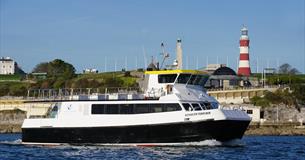 Plymouth Venturer at sea with Plymouth Hoe backdrop