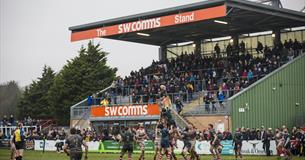 View of Plymouth Albion playing Rugby with spectators watching.