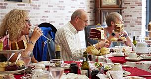 People sat at tables inside the tea rooms eating afternoon tea served from tiered cake stands.