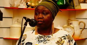 Photograph of a woman talking into a microphone