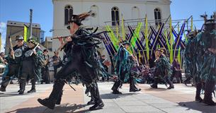 Photograph showing a group of Morris Dancers outside The Box in Plymouth