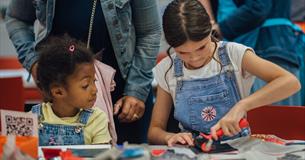 Two girls take part in a craft activity