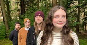Matt, Olly, Luke and Jess from Wild Fenn standing in the forest.