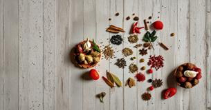A collection of garlic, chilli, ginger and loose spices across a table