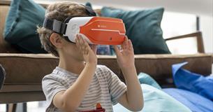 little boy wearing a VR headset