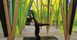 jules doing a headstand on a yoga mat