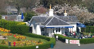 Valenti's and adjacent gardens shown from Plymouth Hoe with people sat outside