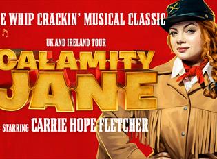 Carrie Hope-Fletcher as Calamity. Red backdrop.