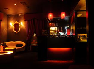 The dimly lit interior of Annabel's with lights and seating area.