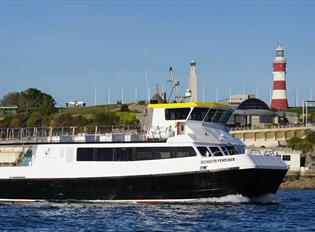 Plymouth Venturer at sea with Plymouth Hoe backdrop