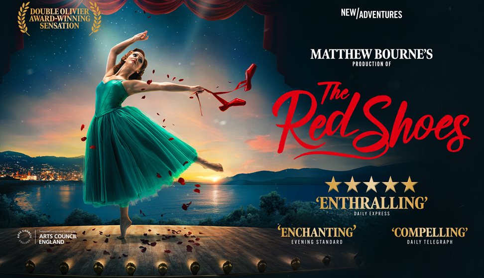 Women on pointe in blue dress and red ballet shoes in hand.