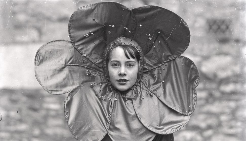 black and white photo of the girl wearing a flower collar