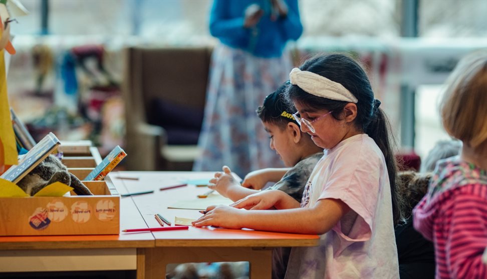 Two girls take part in a craft activity at The Box Plymouth
