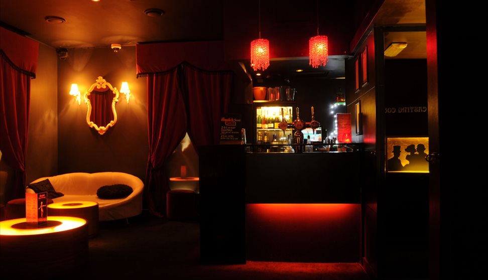 The dimly lit interior of Annabel's with lights and seating area.