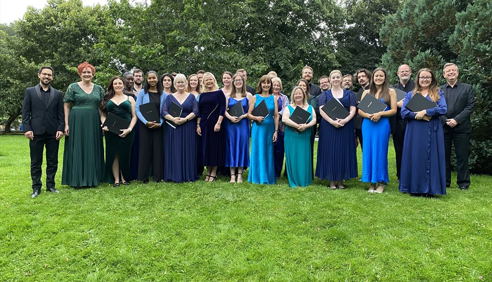 A group of people dressed smartly holding music books