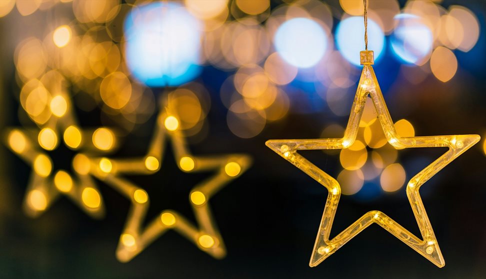 A photograph showing illuminated star decorations