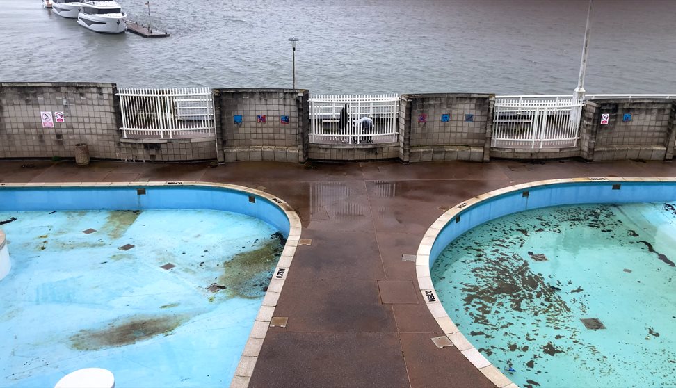 Photograph showing an outdoor pool out of season.