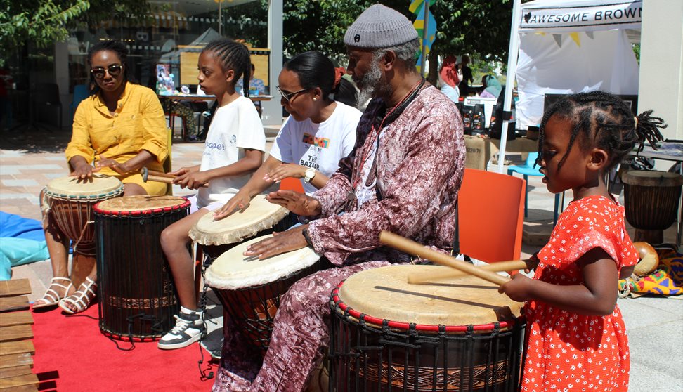 Photograph showing a group of people playing drums