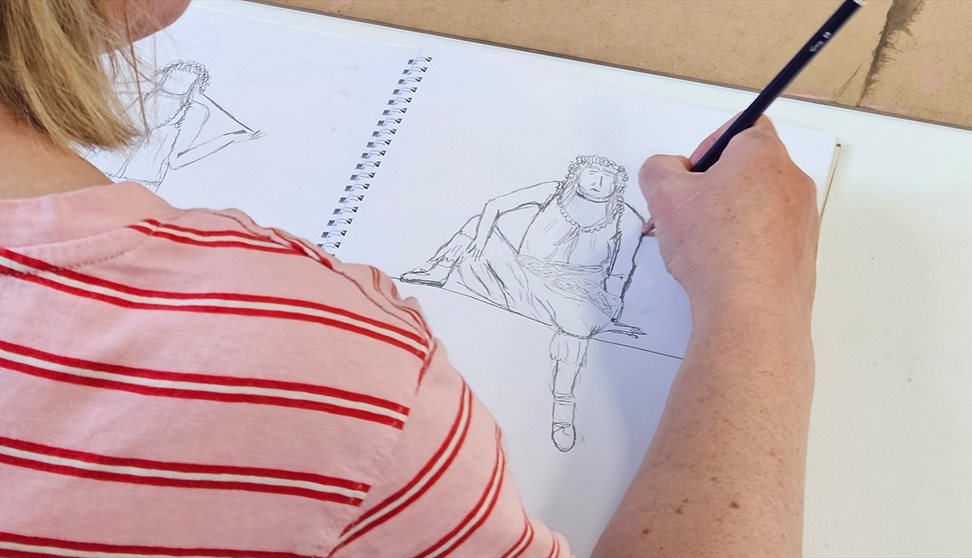A woman takes part in a life drawing workshop
