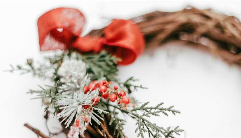 A photograph showing a closeup of a Christmas wreath