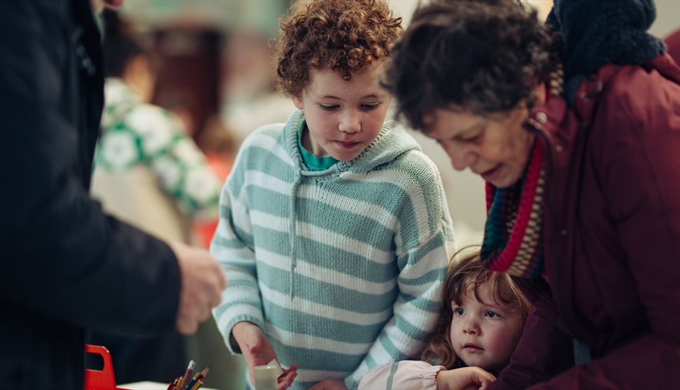 A family take part in a craft workshop at The Box Plymouth