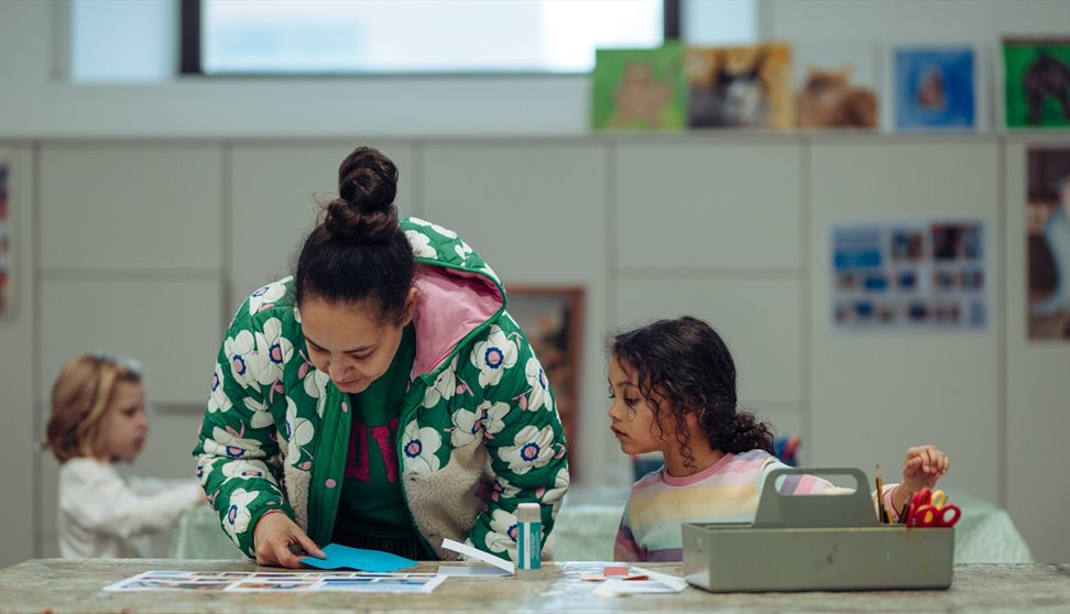 A parent and young girl take part in a craft activity at The Box Plymouth