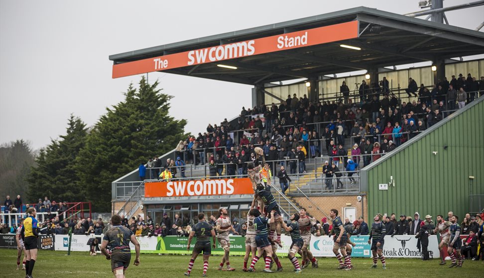 View of Plymouth Albion playing Rugby with spectators watching.