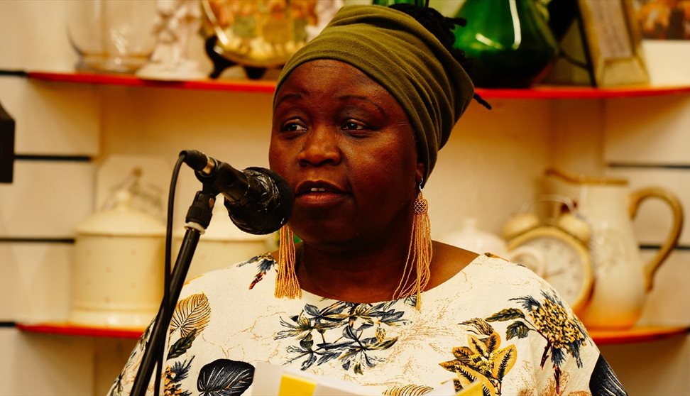 Photograph of a woman talking into a microphone