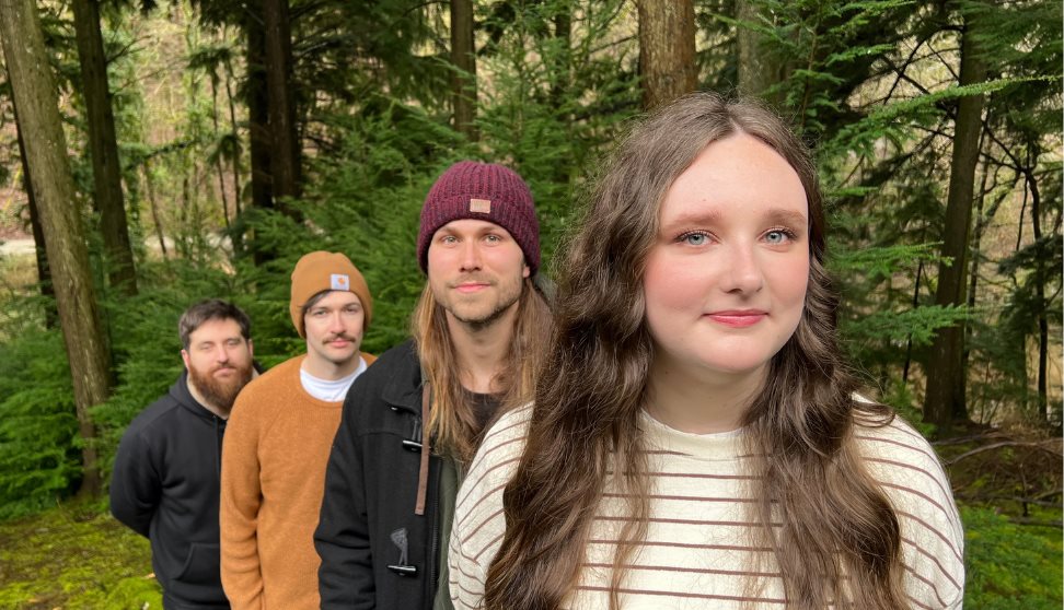 Matt, Olly, Luke and Jess from Wild Fenn standing in the forest.
