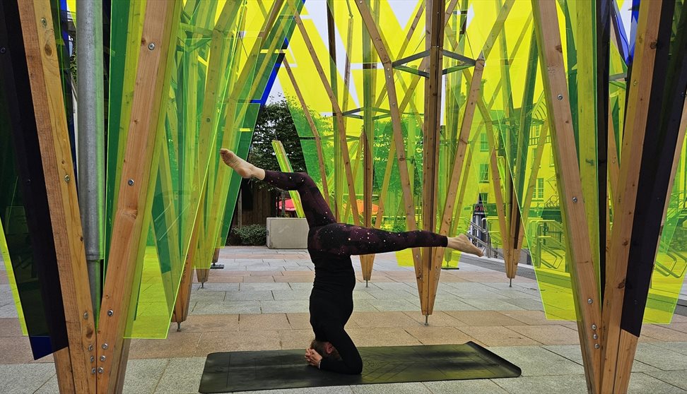 jules doing a headstand on a yoga mat