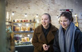 Visitors exploring an indoor Christmas market