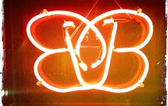 Brightly lit neon sign of the B-bar