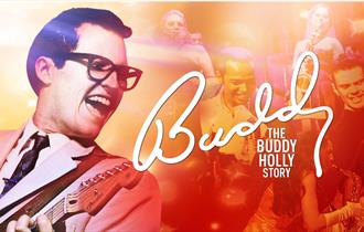 Colourful image of Buddy Holly with guitar