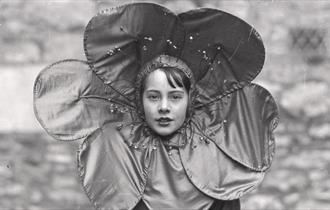 black and white photo of the girl wearing a flower collar