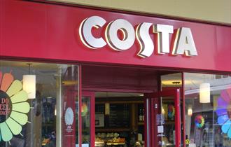 An external shot of Costa showing the shop front windows and the large Costa sign.