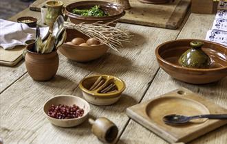 An array of ingredients in bowls set out on a wooden table