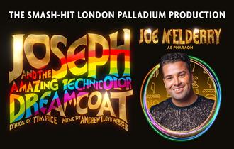 Joe McElderry as Pharaoh. Black backdrop with gold and rainbow 'Joseph and the Amazing Technicolor Dreamcoat.