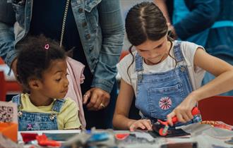 Two girls take part in a craft activity