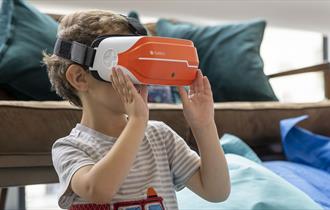 little boy wearing a VR headset