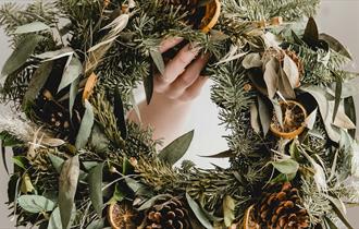 a person holding a wreath