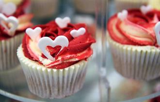 Romantic cupcake with red icing and love hearts at the Studio Lounge