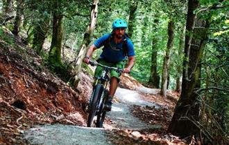 Cyclist riding through Drakes Trail.