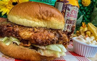 Burger and chips, with ginger beer in the background