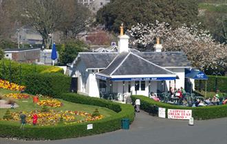 Valenti's and adjacent gardens shown from Plymouth Hoe with people sat outside
