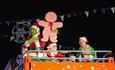Santa, the Grinch and friends on top of the bus at the Barbican Christmas Lights switch on