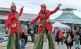 Stilt walkers at the Barbican Christmas Lights switch on in Plymouth
