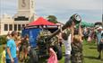 Children interacting with military equipment and vehicles at Armed Forces Day